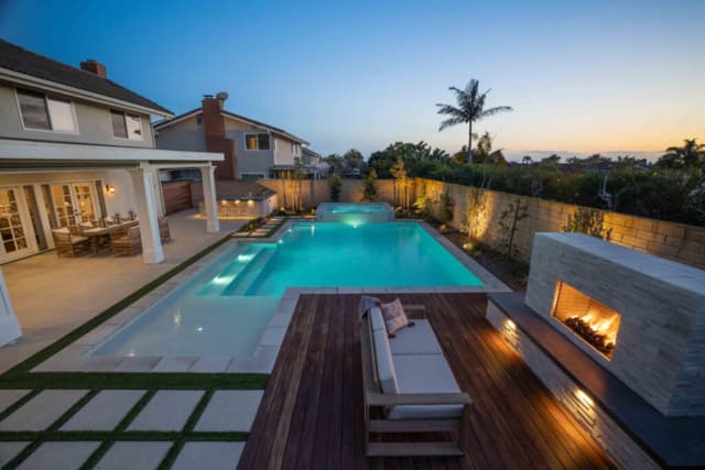 Long rectangular pool beside the home at twilight